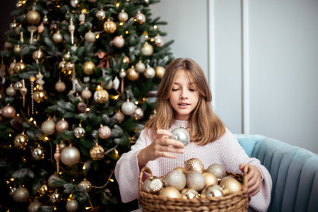 Cute teenage girl in a room with a decorated Christmas tree. The winter holidays. high quality photoの写真素材