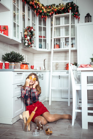 Cute teenage girl in a room with a decorated Christmas tree. The winter holidays. high quality photoの写真素材
