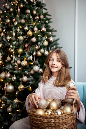Cute teenage girl in a room with a decorated Christmas tree. The winter holidays. high quality photoの写真素材