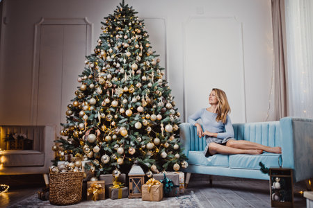 Young woman near the Christmas tree. Winter holidays.の写真素材