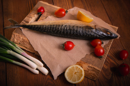 Mackerel on the table with vegetables. Home cooking, fish menu.