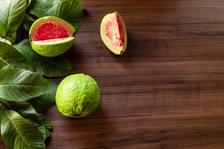 Beautiful fresh red guava, autumn fruit on wooden rustic backgroundの写真素材