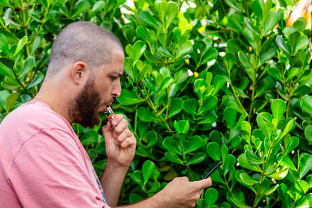 Bald and bearded man smoking.の写真素材