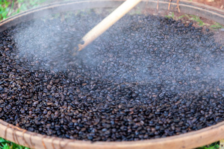 Roasted coffee beans, just came out of the fire, hot, smoke coming out.