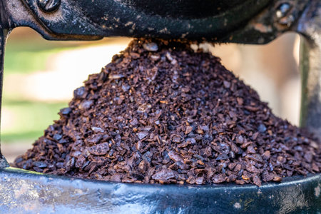 Ground coffee in the manual grinder.