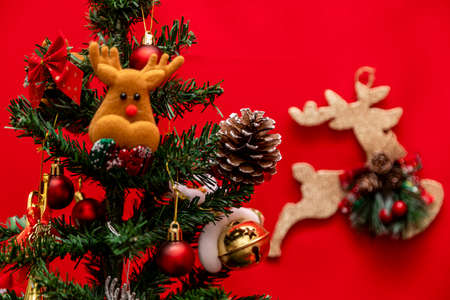 Decorated Christmas tree on red background.の写真素材