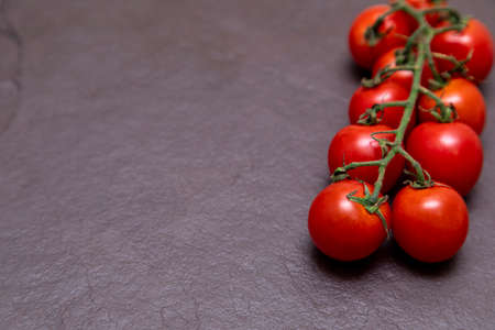 Red cherry tomato on a stone backgroundの写真素材