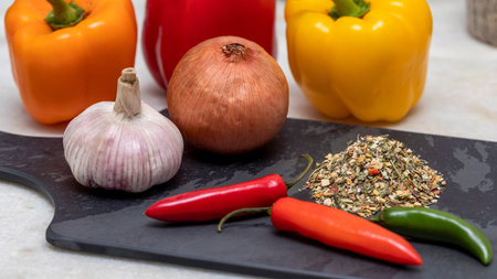 Dehydrated Chimichurri seasoning on black stone with garlic, onion and other spices