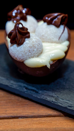 Chocolate easter egg on top of black stoneの写真素材