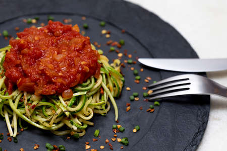 Zucchini spaghetti with dehydrated pepperoni pepper and red sauce.の写真素材