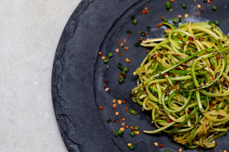 Zucchini spaghetti with dehydrated pepperoni pepper.
