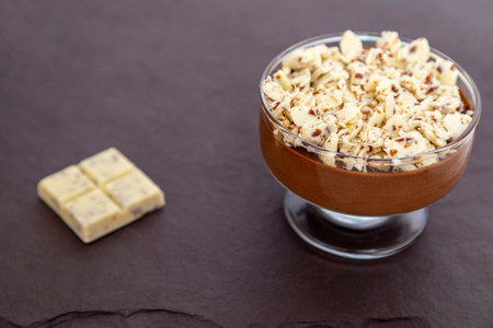 Milk chocolate mousse with chocolate shavings.