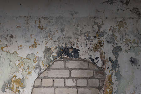 The texture of a worn out, old concrete wall with peeling paint.の写真素材