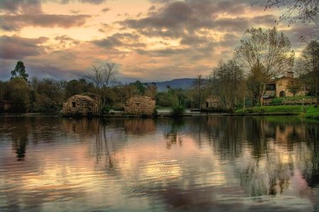 Night falling on a river house.の写真素材