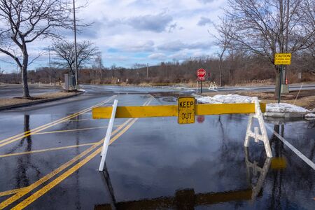 Road in forest belt blocked by sign prohibiting entryの写真素材