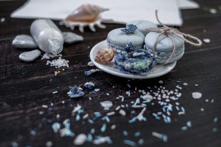 Food decorating with sea details such as shells, stones, salt, rope on wood background with blue ribbonの写真素材