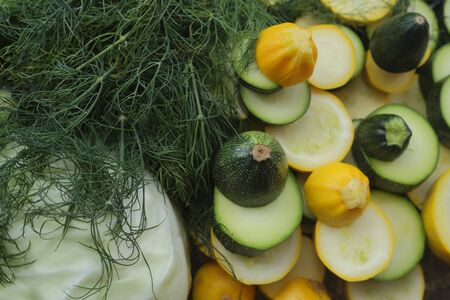 Zucchini, cabbage and dill, sliced rings, and other vegetables, surrounded with cucumbers, cabbage and dill.の写真素材