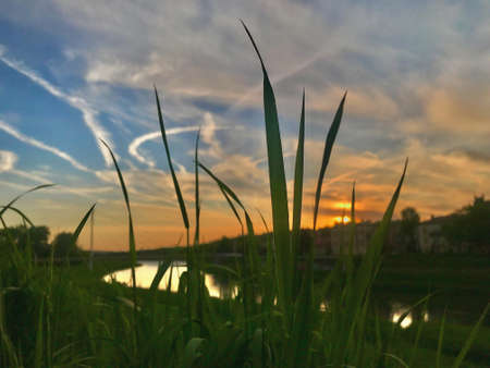 Sunset overlooking the river San in Przemysl, Poland.The clouds are beautifully smeared across the sky and shimmer with all the colors of the rainbow.の写真素材