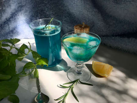 Blue cold drink in a glass with ice cubesの写真素材