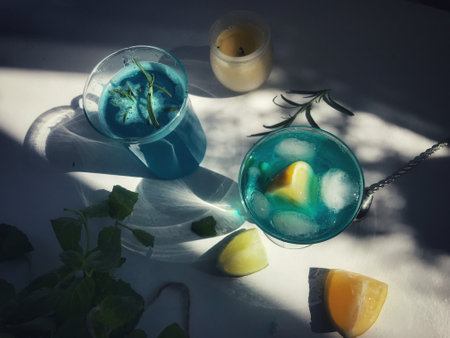 Blue cold drink in a glass with ice cubesの写真素材