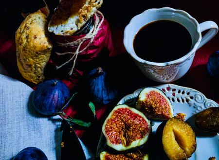 Breakfast variant with butterbroads and fruits such as plums, figs and homemade bread and figs jam and coffee. Natural light used onlyの写真素材