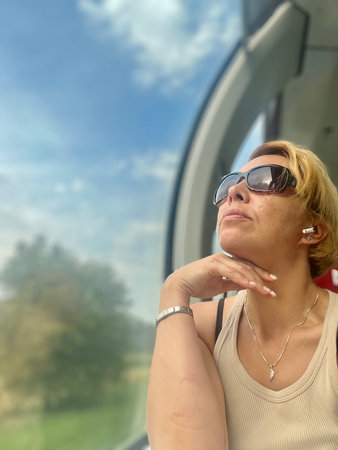 portrait of a woman in sunglasses on a background of the skyの写真素材