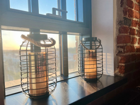 Vintage lanterns on a window sill in the morning sun.の写真素材