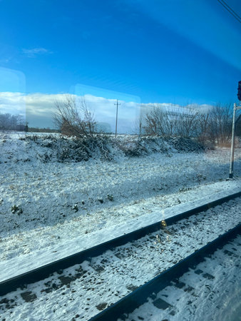 Railway tracks in the snow. Winter landscape with snow and blue sky.