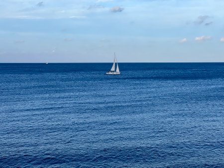 Sailboat in the Mediterranean sea on a background of blue skyの写真素材