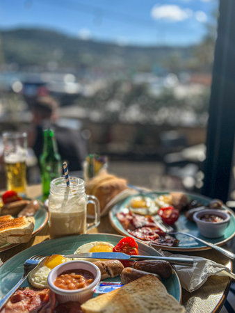 Rich and delicious breakfast on a summer terrace overlooking the sea.