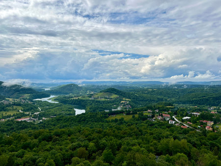 View from the mountain to the city and the river in the clouds