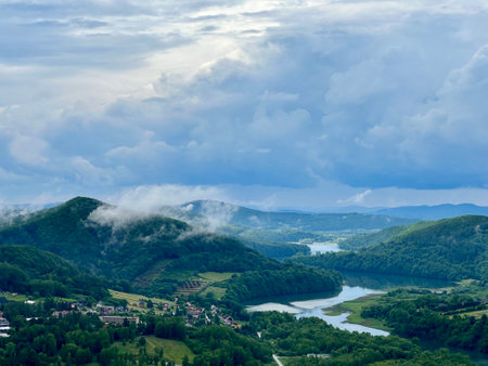 Landscape with river and clouds on the background of the mountains.の写真素材