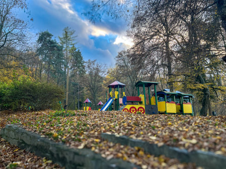 Colorful children's playground in the park on a sunny autumn dayの写真素材
