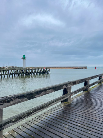 A view of the pier at the end of the beach on a winter dayの写真素材