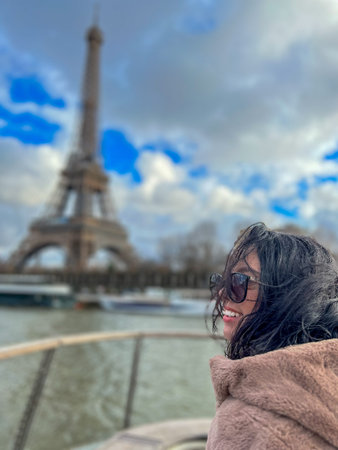 Young woman in Paris, France with Eiffel tower in the background