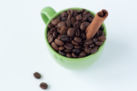 Coffee beans in a green cupの写真素材