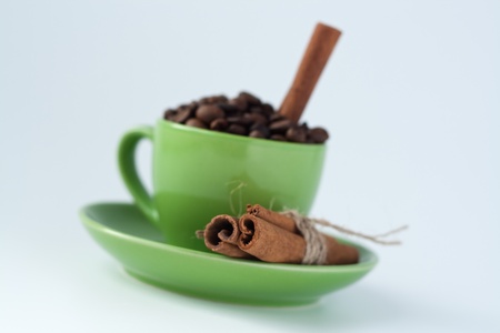 Coffee beans in a green cupの写真素材