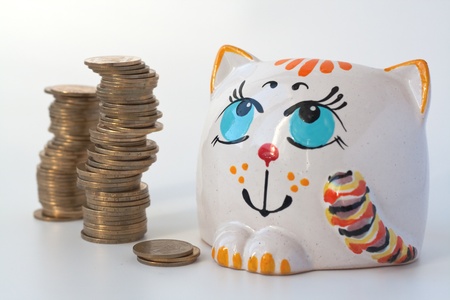 Money bank for money and coins on a white backgroundの写真素材