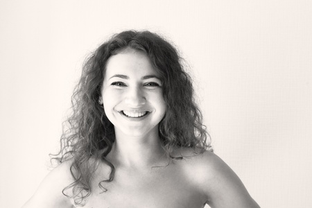 Portrait of a beautiful young brunette with curly hairの写真素材