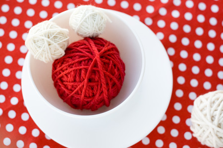Bright balls of yarn in a cupの写真素材
