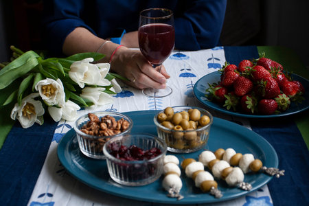 A gourmet break: a plate of strawberries, small bowls of cranberries, olives and walnuts, mozzarella...