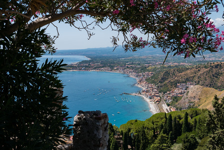 Taormina Bay in a summer day seen from greek theater in Taormina , Sicily, Italyの写真素材