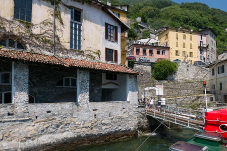 BRIENNO, ITALY - 1 JULY 2018:  Tourists waiting for the boat at the Brienno stop on Lake Comoの写真素材