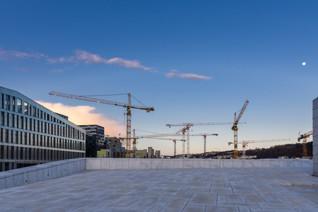 group of moving cranes seen from the roof of the Oslo Opera houseのeditorial素材