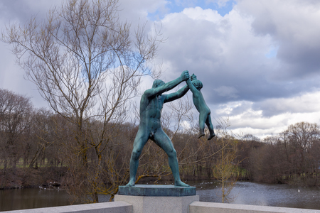 OSLO, NORWAY 27 APRIL 2018: sculpture of a man playing with a child at Vigeland Park in Osloのeditorial素材