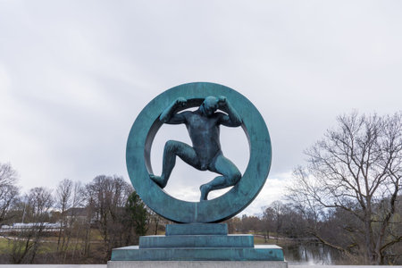 OSLO, NORWAY APRIL 27, 2018: sculpture of man inside a circle at Vigeland park in Osloのeditorial素材
