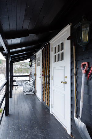 porch of a wooden cottage with various tools and old skis, norwayの写真素材