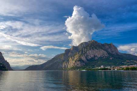 Panorama of Lecco with the mountains in the background and a huge cloud on Mount San Martino,Italyの写真素材