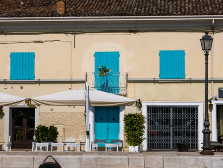 CESENATICO - 7 AUGUST 2018: colored windows of a house in the Porto Leonardesco canal of Cesenatico...