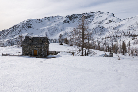 stone mountain refuge in a snowy landscape, italyのeditorial素材